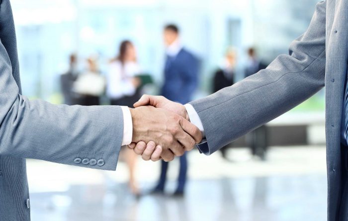 Men shaking hands after closing a deal - Mincoffs Solicitors