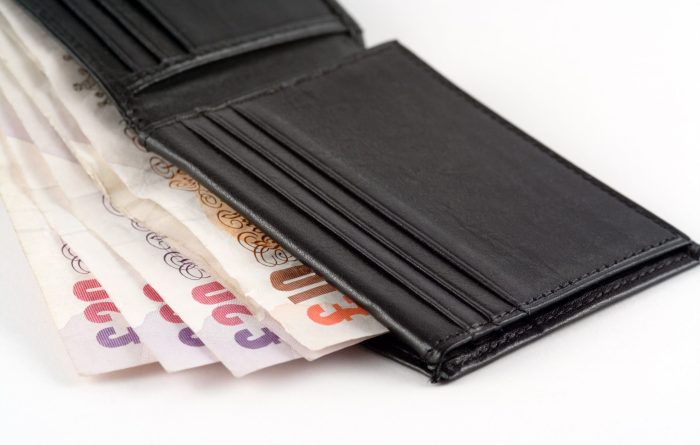 open wallet containing UK bank notes