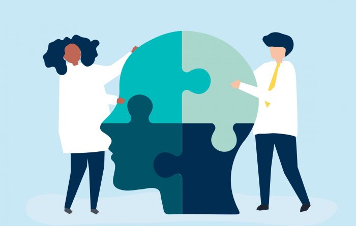 People connecting jigsaw pieces of a head together