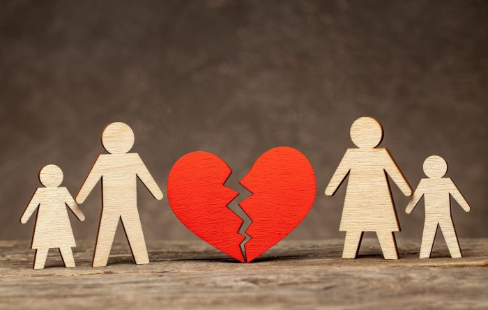 A father and daughter on one side of a broken heart and mother and son on the other side