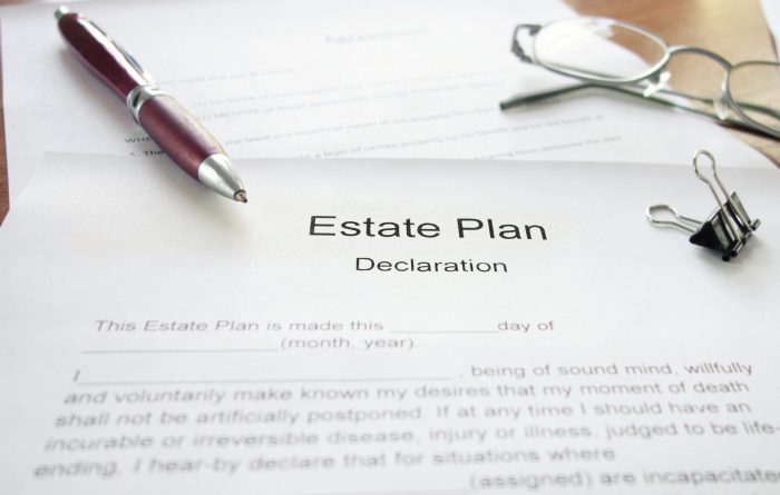 Estate plan declaration document on a table with a pen and glasses