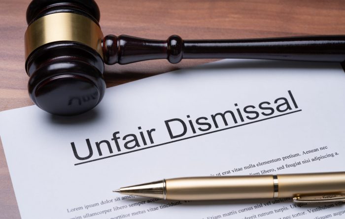 Documents of unfair dismissal with gavel and pen